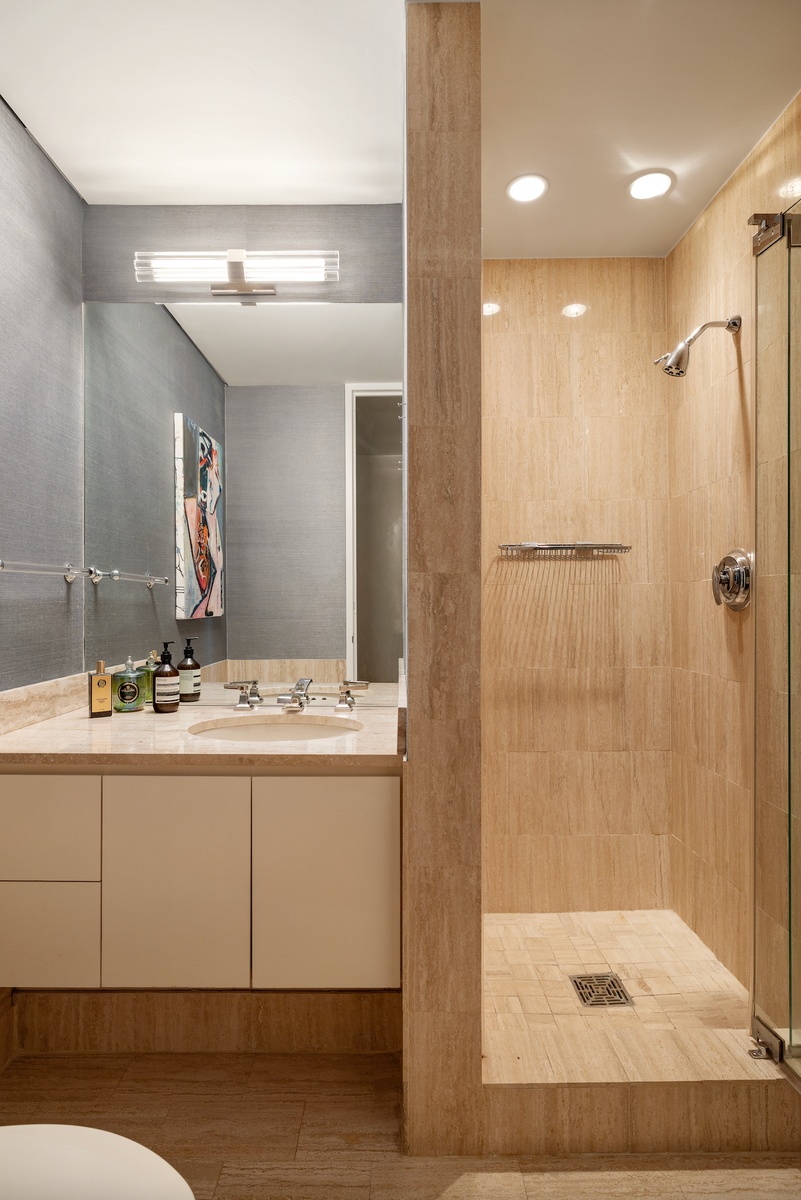 15 West 53rd Street, Unit 14G Manhattan, NY 10019 - Photo 6 of 10 a bathroom with a sink and a mirror