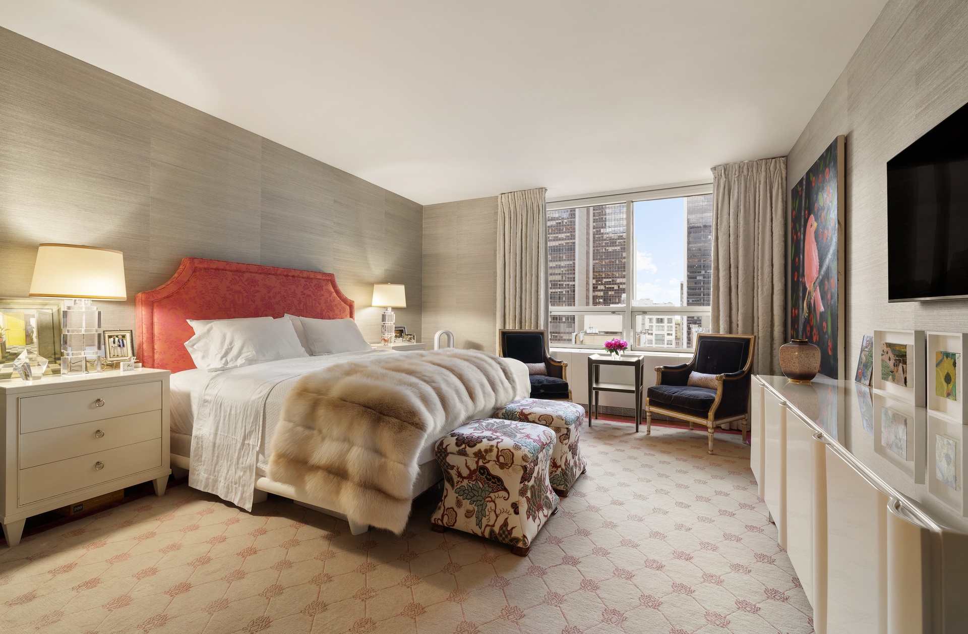 15 West 53rd Street, Unit 14G Manhattan, NY 10019 - Photo 8 of 10 a bedroom with a bed and flat screen tv