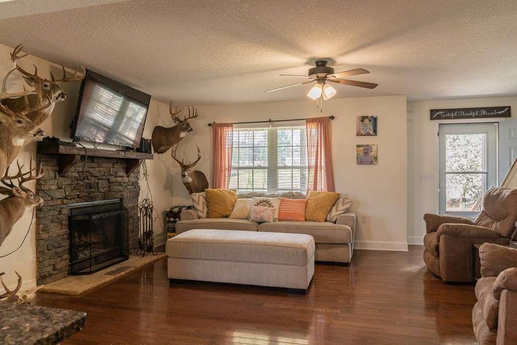 957 Bethlehem Road Rockmart, GA 30153 - Photo 12 of 33 a living room with furniture a fireplace and a flat screen tv