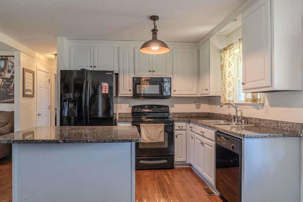 957 Bethlehem Road Rockmart, GA 30153 - Photo 13 of 33 a kitchen with stainless steel appliances granite countertop a stove refrigerator and microwave