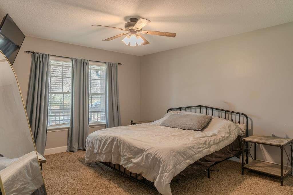 957 Bethlehem Road Rockmart, GA 30153 - Photo 18 of 33 a bedroom with a bed and a chandelier