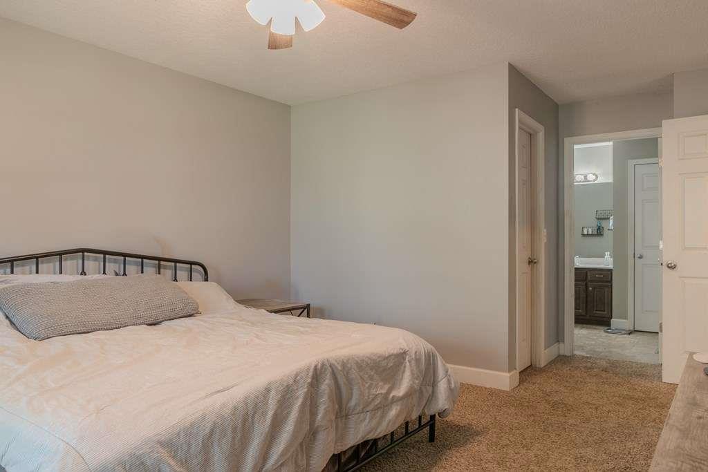 957 Bethlehem Road Rockmart, GA 30153 - Photo 19 of 33 a bedroom with a bed and a chandelier