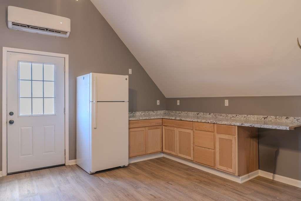957 Bethlehem Road Rockmart, GA 30153 - Photo 30 of 33 an empty room with wooden floor and cabinet