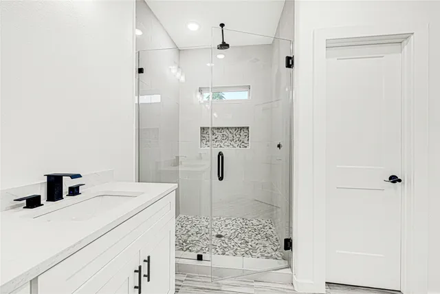 a bathroom with a shower and sink