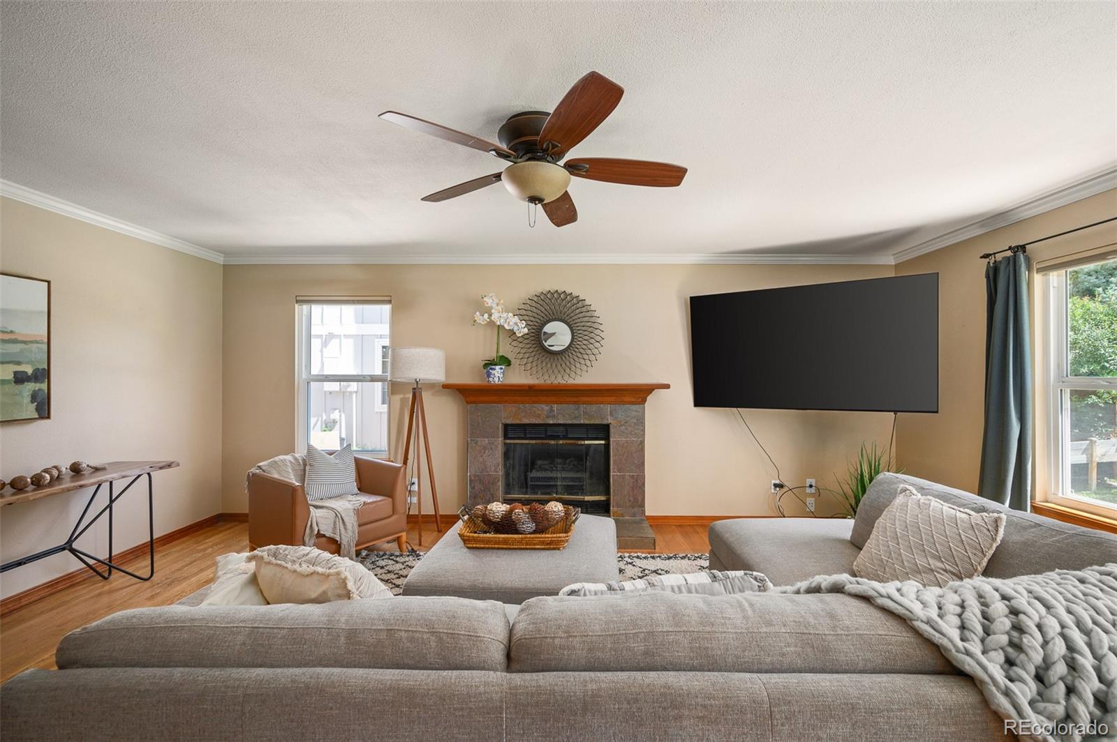 7412 Berkeley Court Castle Pines, CO 80108 - Photo 11 of 37 a living room with furniture a fireplace and a large window