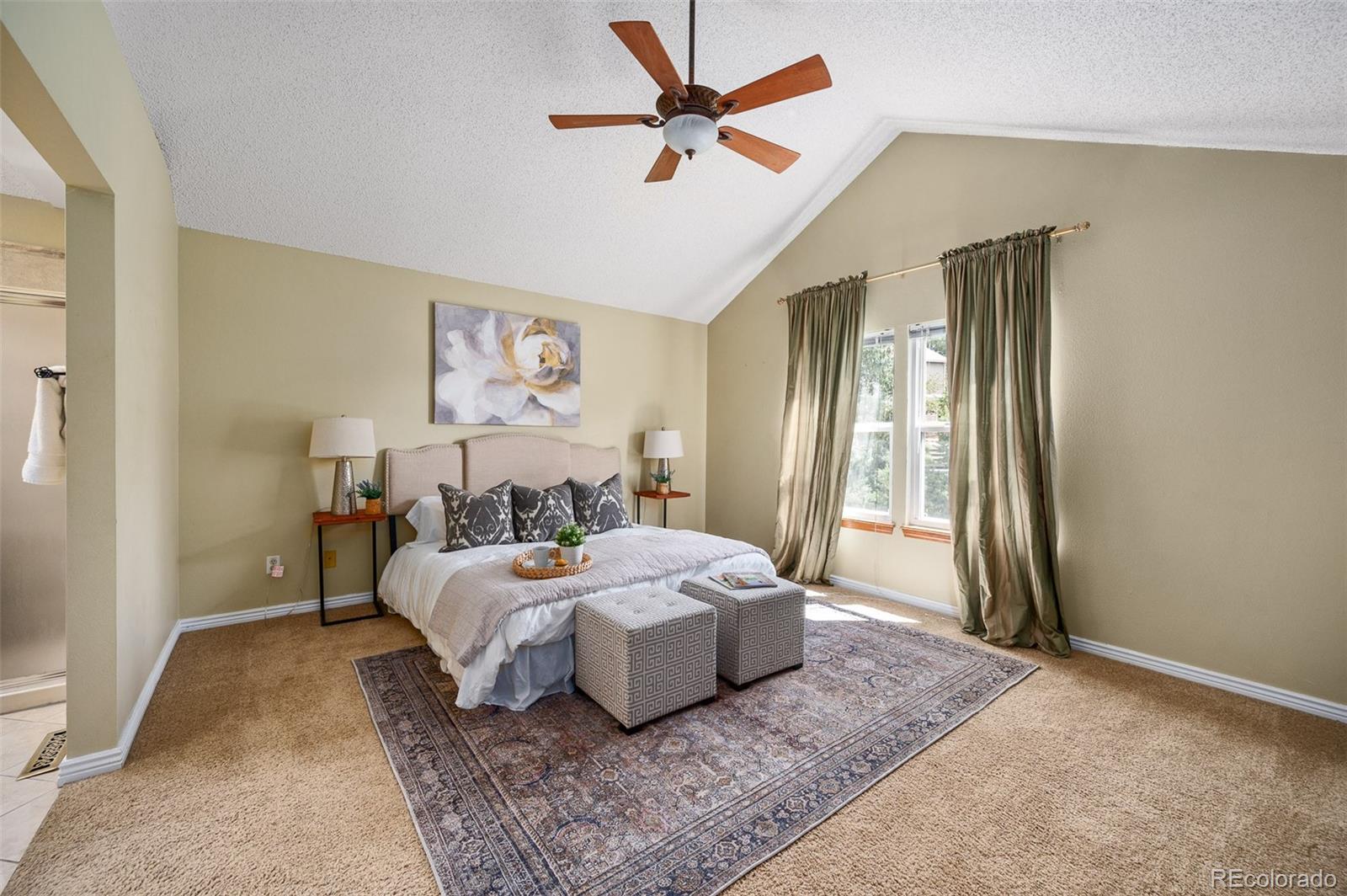 7412 Berkeley Court Castle Pines, CO 80108 - Photo 14 of 37 a room with a bed and a chandelier