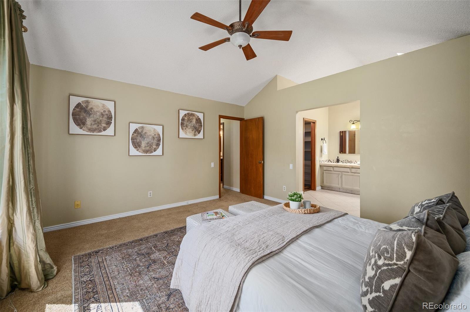7412 Berkeley Court Castle Pines, CO 80108 - Photo 16 of 37 a bedroom with a large bed the view of a bedroom