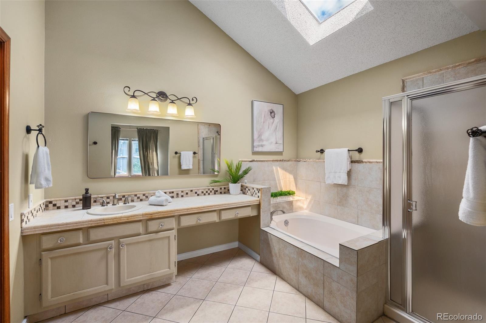 7412 Berkeley Court Castle Pines, CO 80108 - Photo 17 of 37 a bathroom with a sink a tub and a mirror