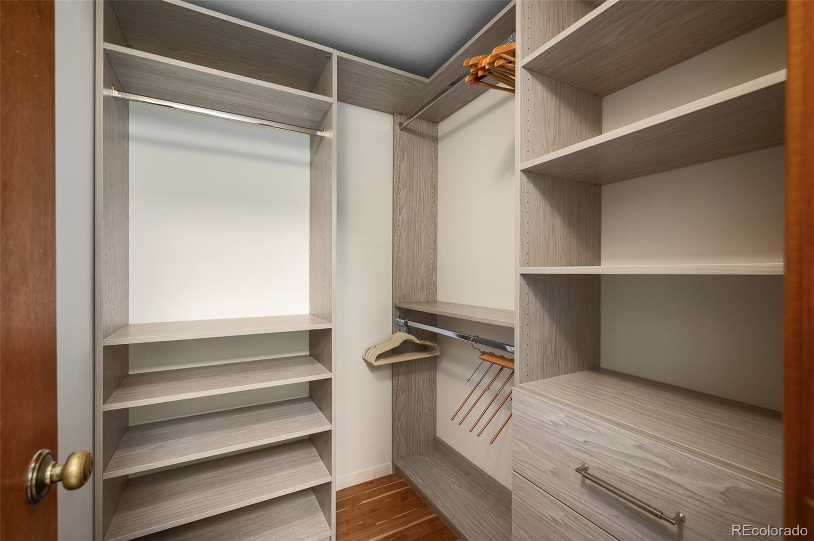 7412 Berkeley Court Castle Pines, CO 80108 - Photo 19 of 37 a view of walk in closet with empty racks