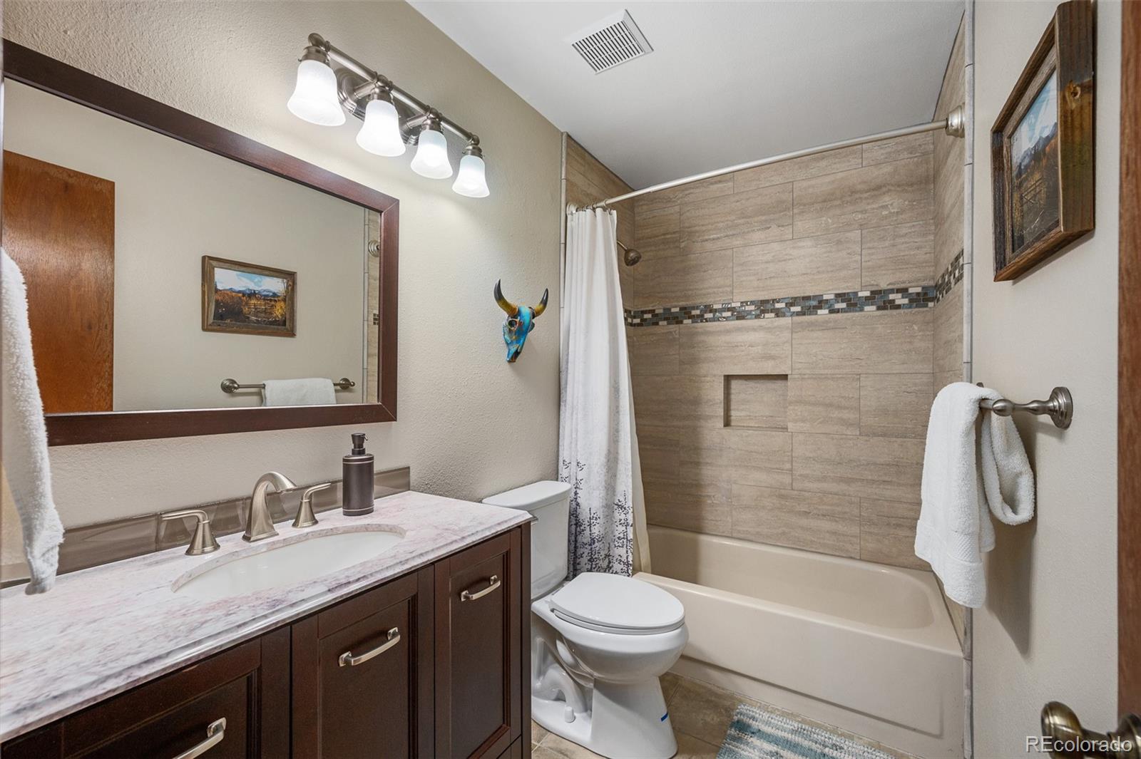 7412 Berkeley Court Castle Pines, CO 80108 - Photo 21 of 37 a bathroom with a granite countertop sink toilet and shower