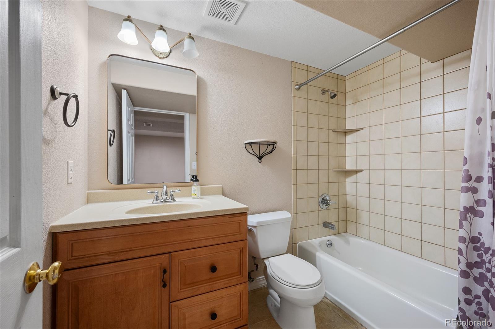 7412 Berkeley Court Castle Pines, CO 80108 - Photo 29 of 37 a bathroom with a sink a toilet and shower