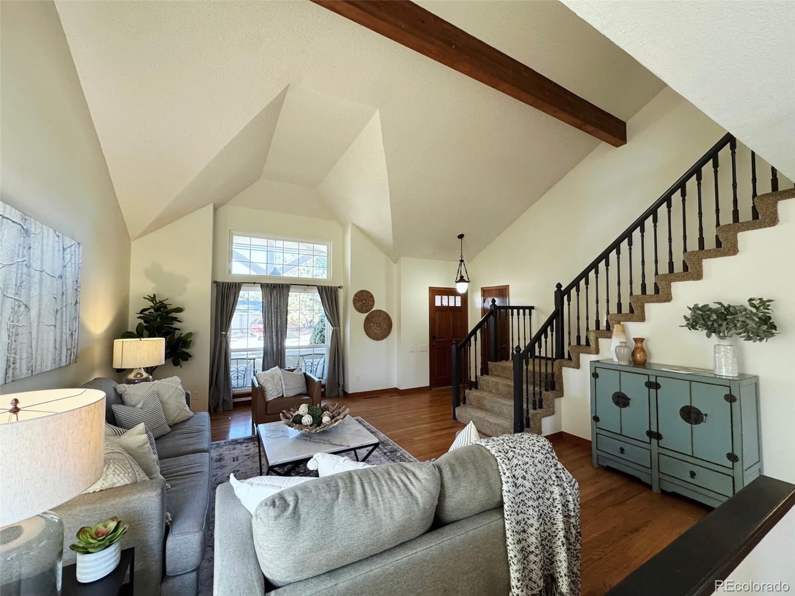7412 Berkeley Court Castle Pines, CO 80108 - Photo 4 of 37 a living room with furniture and wooden floor