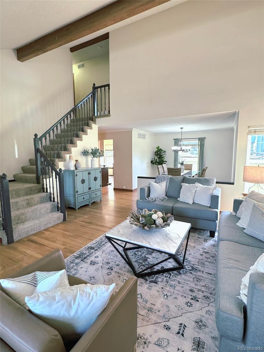 7412 Berkeley Court Castle Pines, CO 80108 - Photo 5 of 37 a living room with furniture and wooden floor