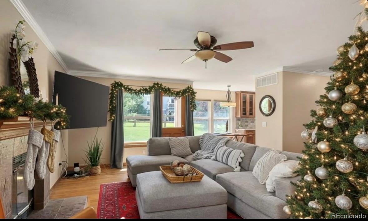 7412 Berkeley Court Castle Pines, CO 80108 - Photo 10 of 37 a living room with furniture and a flat screen tv