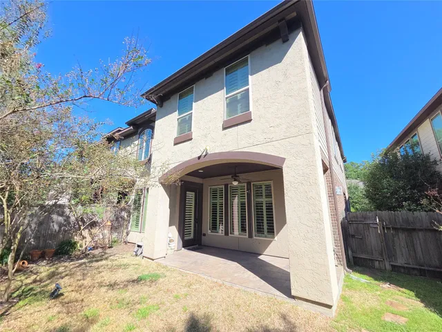 a view of house with backyard and wooden fence