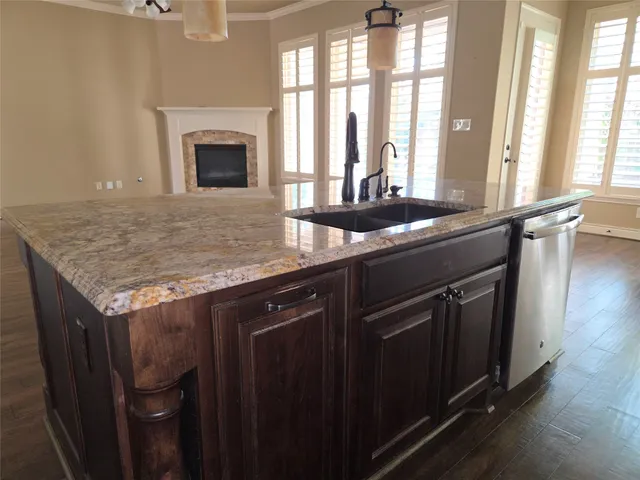 a kitchen with stainless steel appliances granite countertop a stove a sink and a microwave