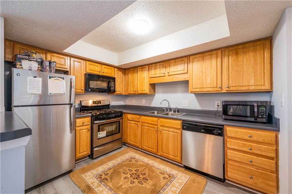 3301 Henderson Mill Road, Unit X4 Atlanta, GA 30341 - Photo 13 of 36 a kitchen with stainless steel appliances granite countertop refrigerator sink and cabinets