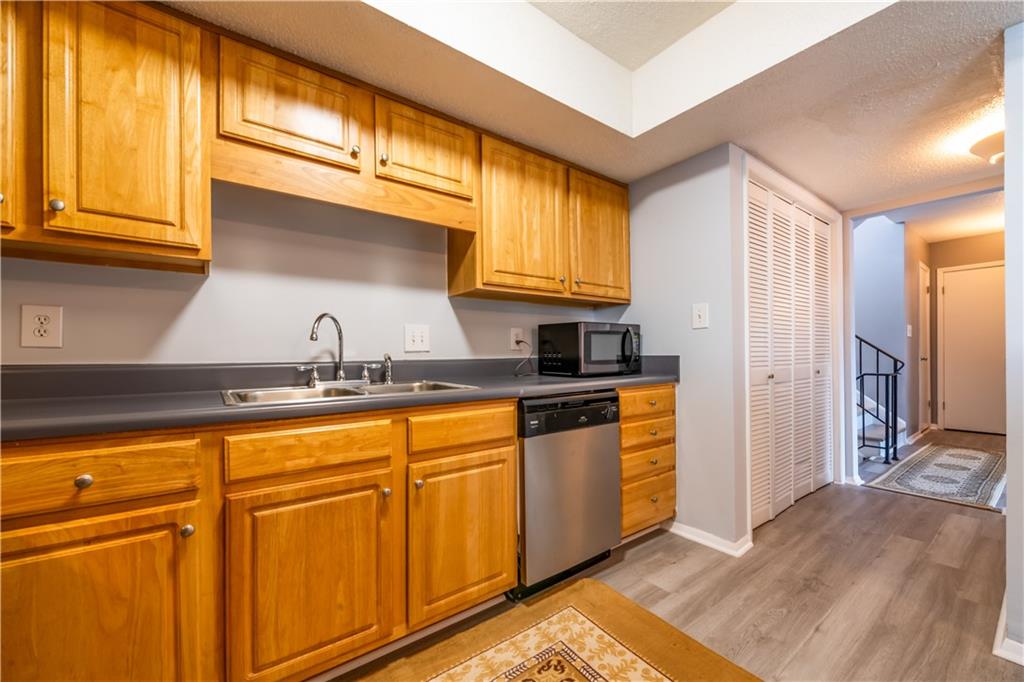 3301 Henderson Mill Road, Unit X4 Atlanta, GA 30341 - Photo 16 of 36 a kitchen with stainless steel appliances granite countertop a sink and cabinets