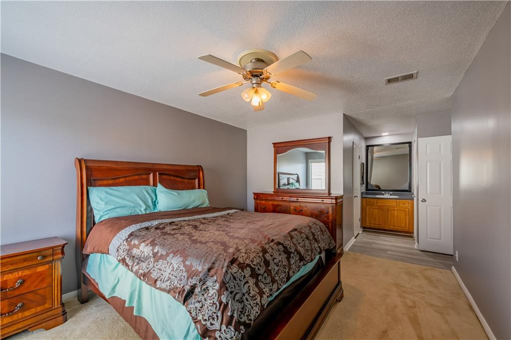 3301 Henderson Mill Road, Unit X4 Atlanta, GA 30341 - Photo 20 of 36 a bedroom with a bed and a chandelier