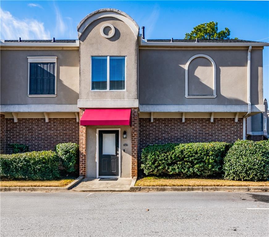 3301 Henderson Mill Road, Unit X4 Atlanta, GA 30341 - Photo 2 of 36 a front view of a house with a garden