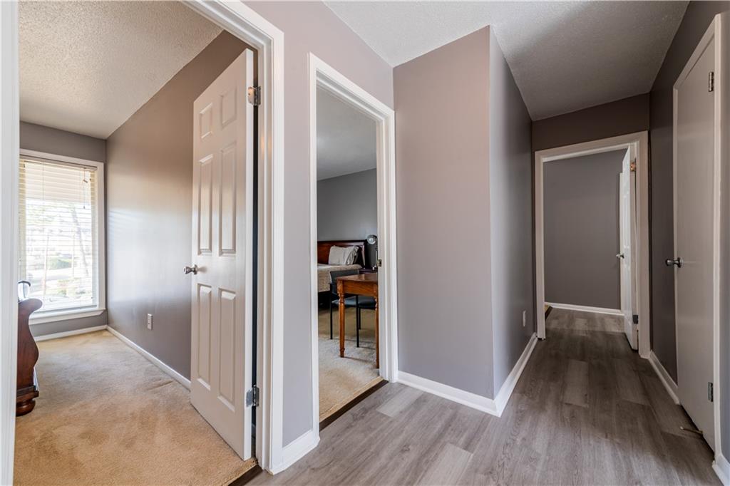3301 Henderson Mill Road, Unit X4 Atlanta, GA 30341 - Photo 30 of 36 a view of a hallway with wooden floor and a livingroom