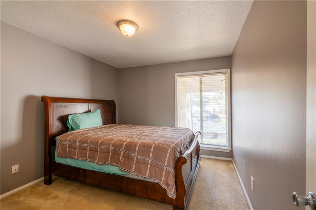 3301 Henderson Mill Road, Unit X4 Atlanta, GA 30341 - Photo 31 of 36 a bedroom with a bed lamp and a window
