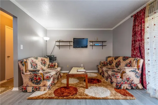 a living room with furniture and wooden floor