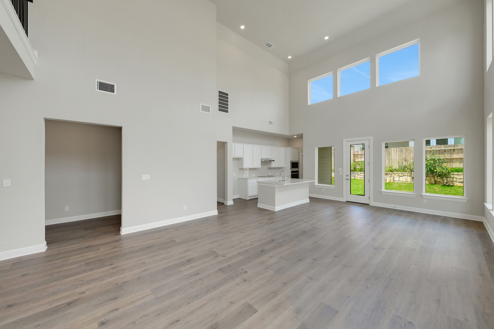 216 Crescent Heights Drive Georgetown, TX 78628 - Photo 7 of 30 a view of a kitchen with wooden floor electronic appliances and windows