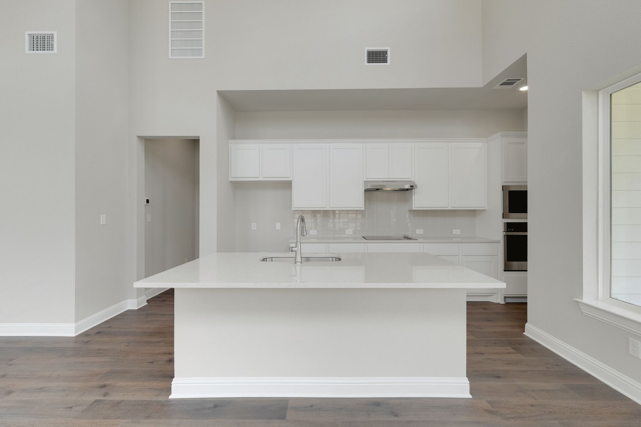 216 Crescent Heights Drive Georgetown, TX 78628 - Photo 9 of 30 a view with granite countertop a sink and dishwasher with wooden floor