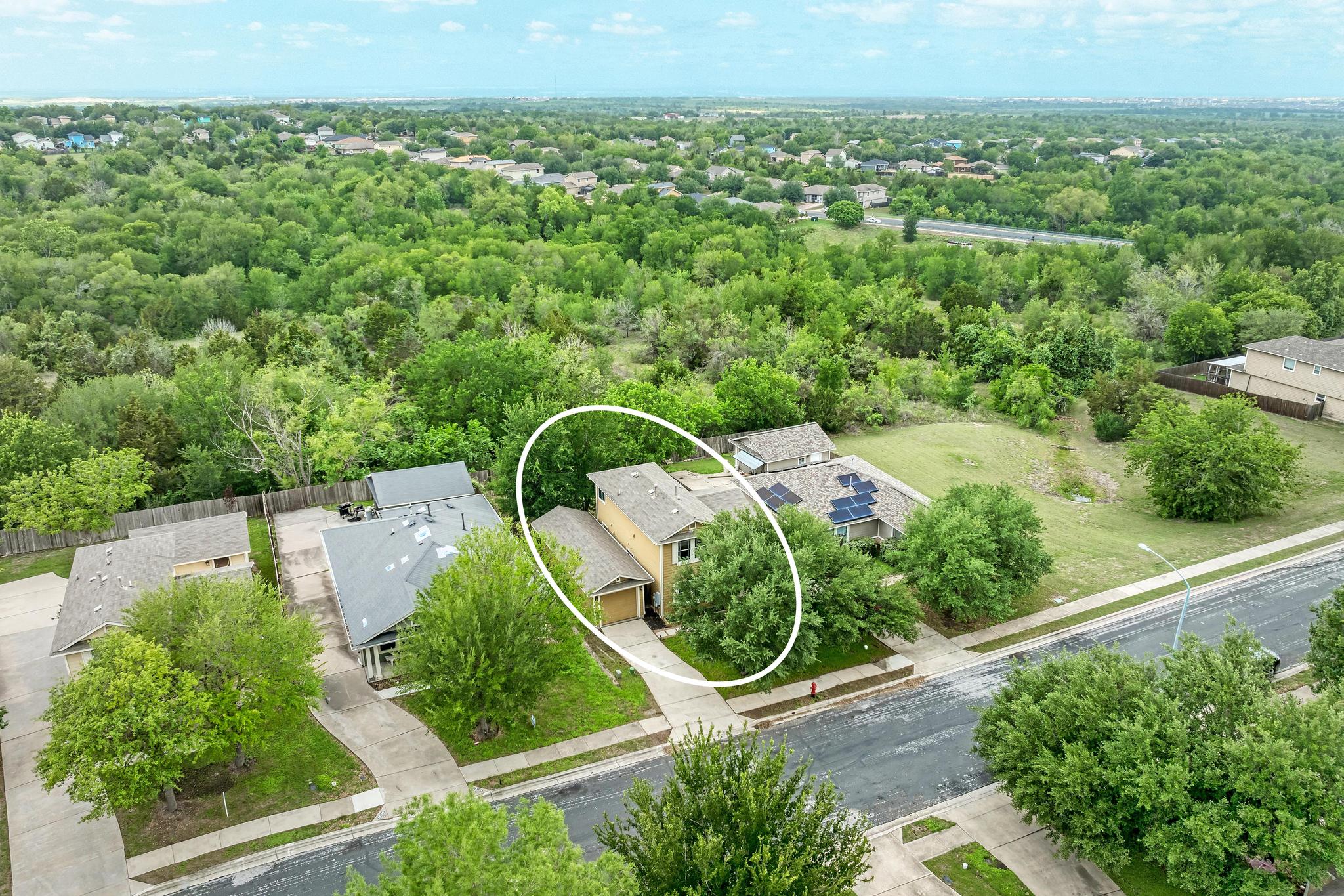 18108 Belfry Pass Manor, TX 78653 - Photo 6 of 40 Aerial view of the property, featuring a surrounding neighborhood with mature trees and green spaces