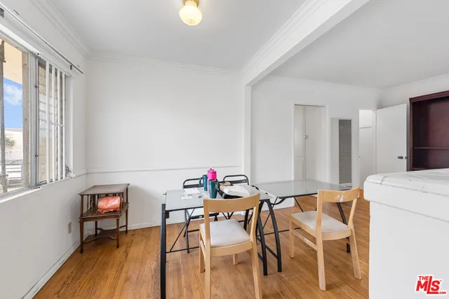 a kitchen with white cabinets and appliances