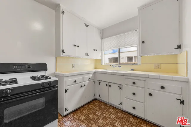 a view of a livingroom with furniture window and wooden floor