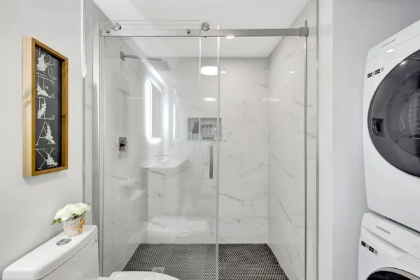 a bathroom with a shower and toilet