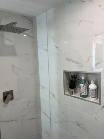a bathroom with a toilet and a shower