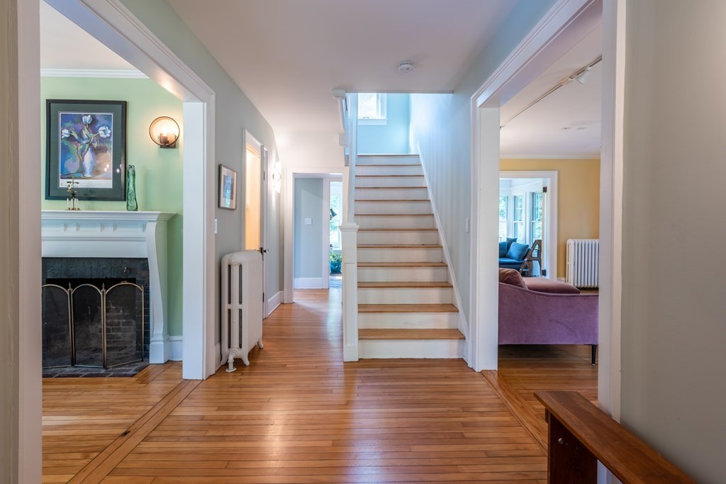 54 Snell Street Amherst, MA 01002 - Photo 12 of 42 a view of a hallway with wooden floor and staircase