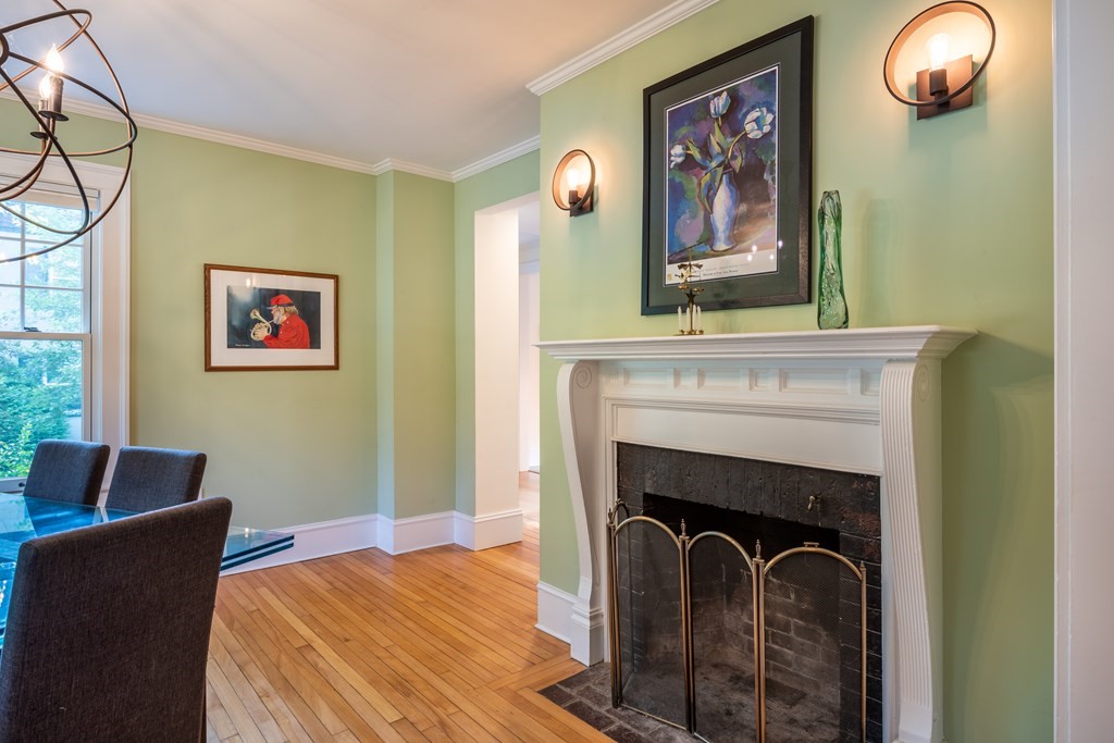 54 Snell Street Amherst, MA 01002 - Photo 15 of 42 a bedroom with a fireplace and a painting on the wall