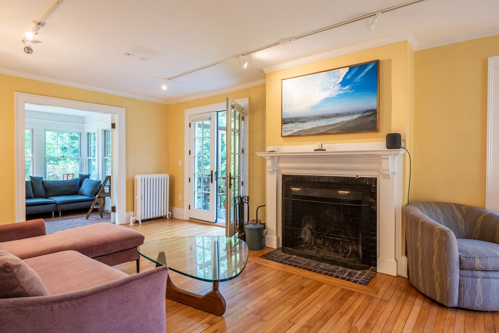 54 Snell Street Amherst, MA 01002 - Photo 18 of 42 a living room with furniture a flat screen tv and a fireplace