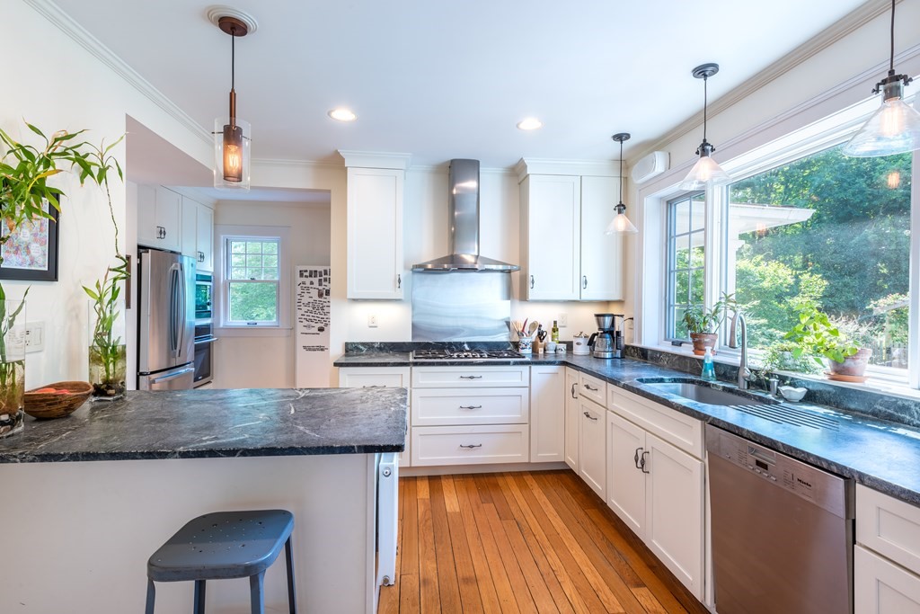 54 Snell Street Amherst, MA 01002 - Photo 25 of 42 a kitchen with a sink stove and cabinets