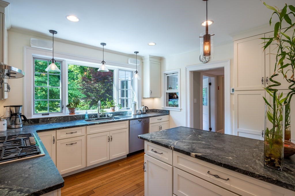 54 Snell Street Amherst, MA 01002 - Photo 28 of 42 a kitchen with stainless steel appliances granite countertop a stove a sink and a refrigerator