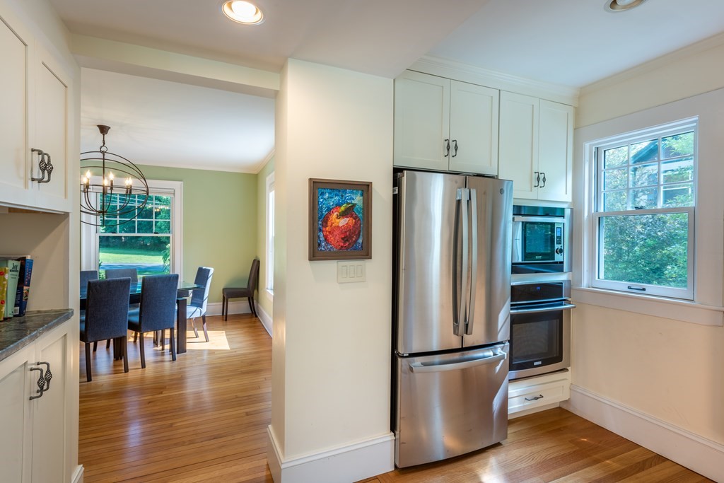 54 Snell Street Amherst, MA 01002 - Photo 29 of 42 a kitchen with stainless steel appliances granite countertop a refrigerator stove and wooden floor