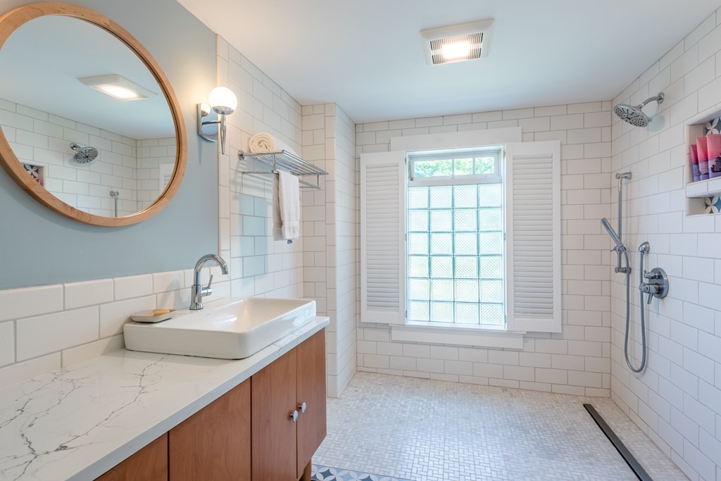 54 Snell Street Amherst, MA 01002 - Photo 34 of 42 a bathroom with a granite countertop sink and a mirror