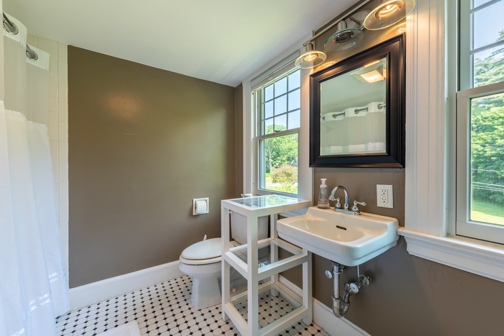 54 Snell Street Amherst, MA 01002 - Photo 38 of 42 a bathroom with a sink a toilet and mirror