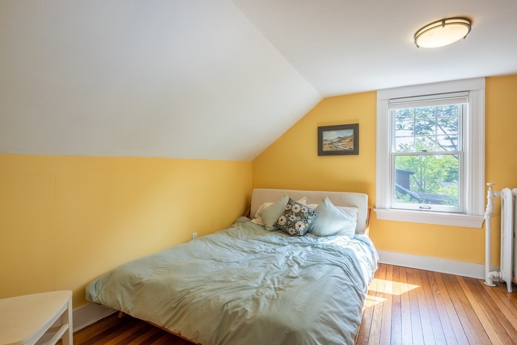 54 Snell Street Amherst, MA 01002 - Photo 39 of 42 a bedroom with a bed and wooden floor