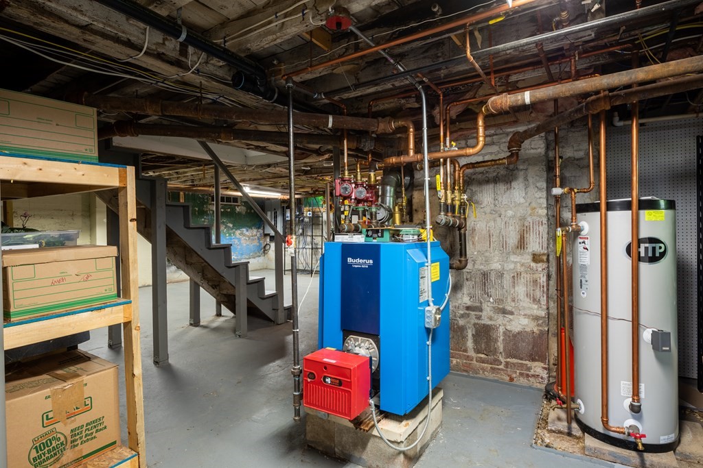 54 Snell Street Amherst, MA 01002 - Photo 42 of 42 a view of water heater room with wooden floor