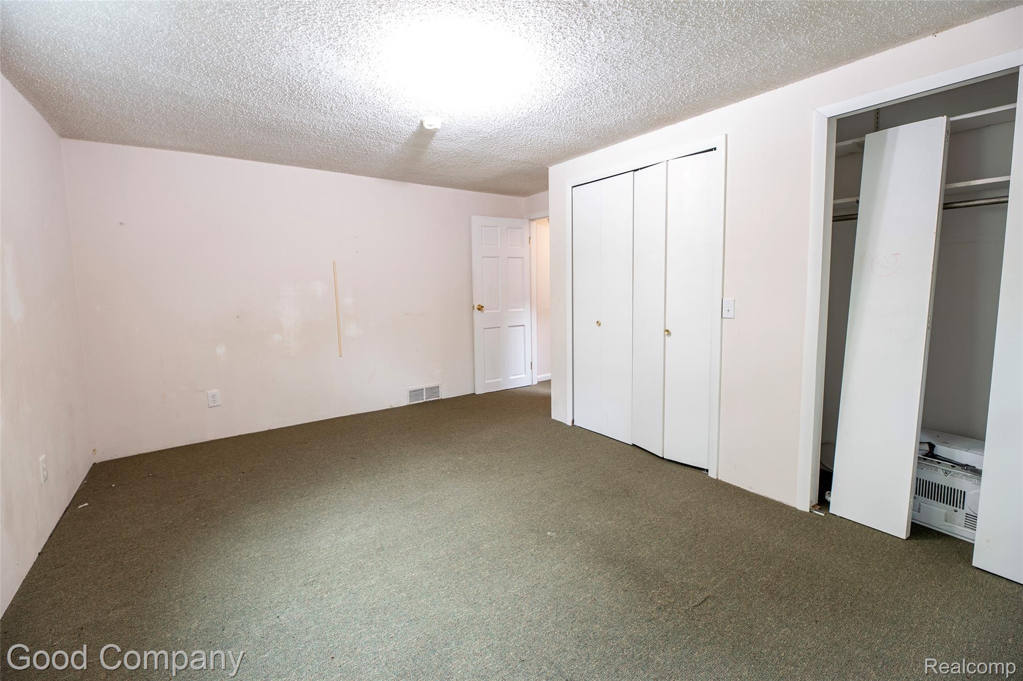 3685 Cone Avenue Rochester, MI 48309 - Photo 15 of 23 Wall-to-wall carpeting with an overhead light fixture, featuring a white bi-fold closet and an additional storage area