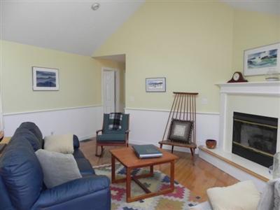 23 Meadowbrook Road Mashpee, MA 02649 - Photo 11 of 20 a living room with furniture a fireplace and a table