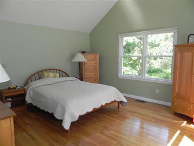 23 Meadowbrook Road Mashpee, MA 02649 - Photo 16 of 20 a bed sitting in a bedroom next to a window