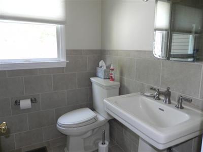 23 Meadowbrook Road Mashpee, MA 02649 - Photo 17 of 20 a bathroom with a sink a toilet and a mirror