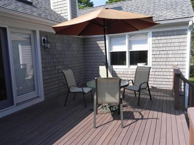 23 Meadowbrook Road Mashpee, MA 02649 - Photo 3 of 20 a patio with wooden floor table and chairs