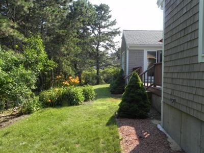 23 Meadowbrook Road Mashpee, MA 02649 - Photo 4 of 20 a backyard of a house with lots of green space